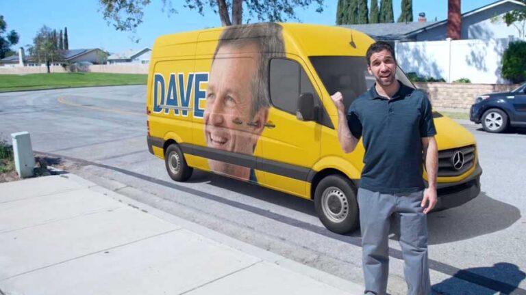 Man posing excitedly next to yellow van with face wrap